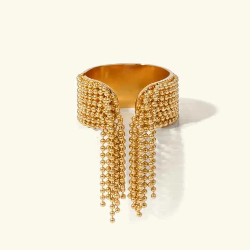 Bague de luxe avec pompons dorés